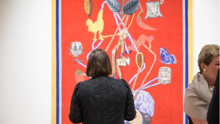 woman in museum looking at artwork